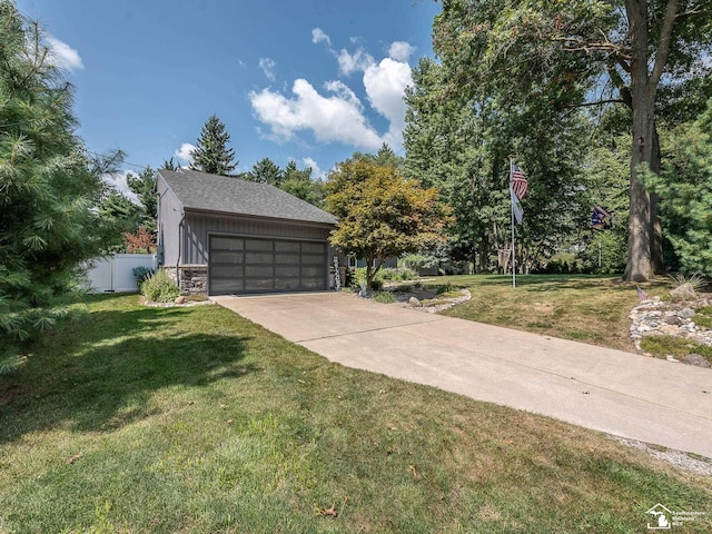 garage with concrete driveway and fence