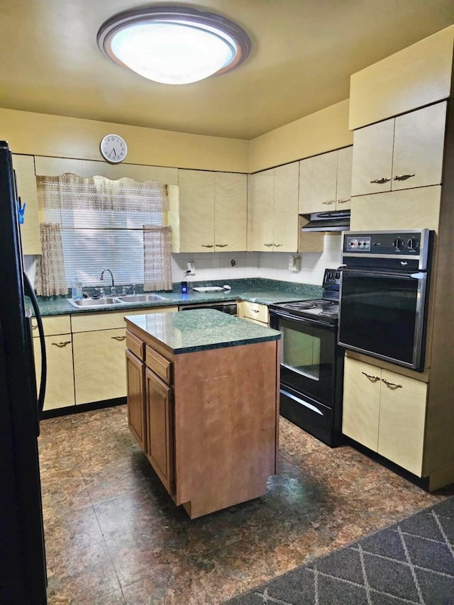 kitchen featuring black appliances, under cabinet range hood, a sink, a kitchen island, and dark countertops