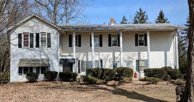 view of front of home featuring a chimney