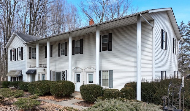 view of front of house featuring a chimney