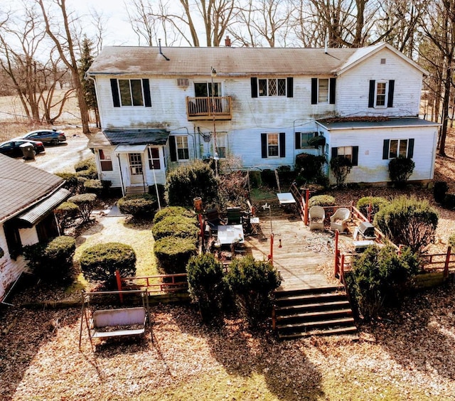 rear view of property with a balcony