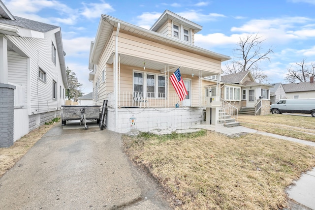 view of front of house with covered porch and a front lawn