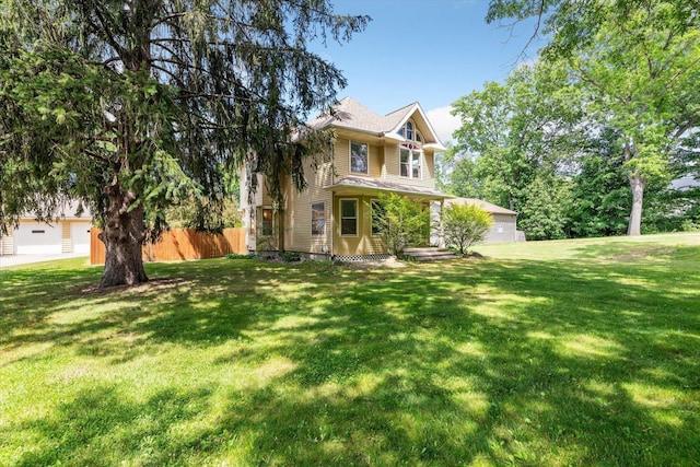 view of front of property with a front lawn and fence