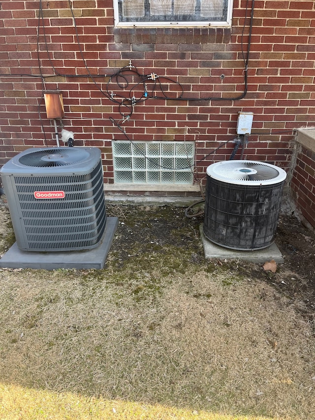 exterior details featuring brick siding and central AC