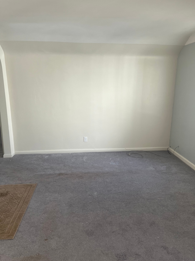 carpeted empty room with baseboards