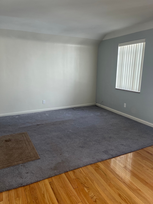 spare room with wood finished floors and baseboards