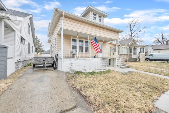 view of front of house with covered porch and a front yard