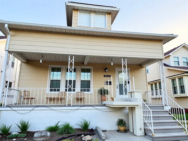 view of front of house featuring a porch and stairs