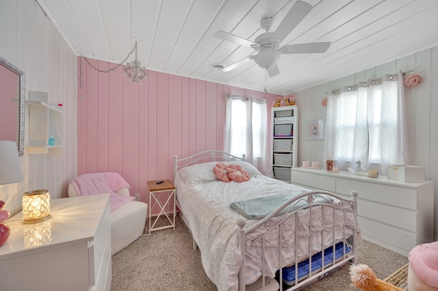 carpeted bedroom featuring wooden ceiling and a ceiling fan