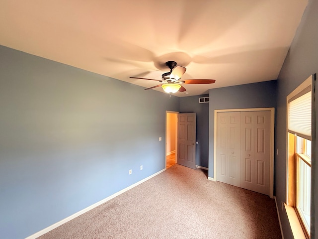 9545 Mcgregor Rd, Pinckney, MI 48169 - unfurnished bedroom with a closet, carpet flooring, baseboards, and a ceiling fan