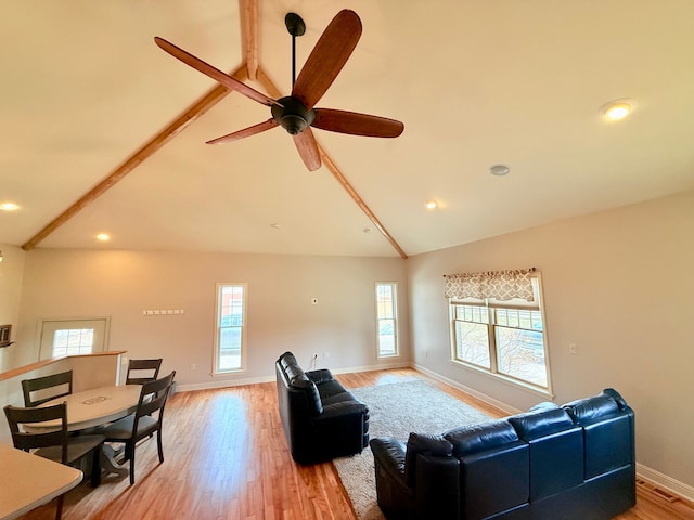 9545 Mcgregor Rd, Pinckney, MI 48169 - living room featuring healthy amount of natural light, baseboards, light wood finished floors, ceiling fan, and beam ceiling