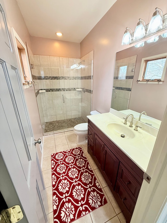 9545 Mcgregor Rd, Pinckney, MI 48169 - full bathroom with tile patterned flooring, a stall shower, vanity, and toilet