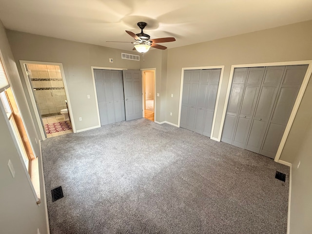 9545 Mcgregor Rd, Pinckney, MI 48169 - unfurnished bedroom featuring multiple closets, carpet, baseboards, ceiling fan, and connected bathroom