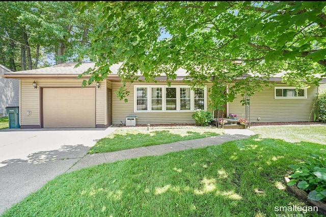 view of front of home featuring a garage, concrete driveway, and a front lawn