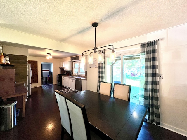 dining room featuring baseboards, a textured ceiling, and dark wood-style floors