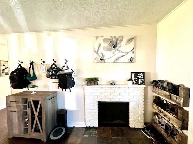 living area featuring a textured ceiling and a brick fireplace