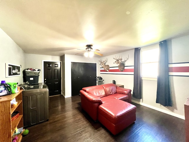 living room with ceiling fan, baseboards, and dark wood finished floors