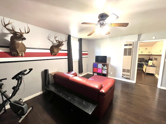 living area with wood finished floors, baseboards, and ceiling fan