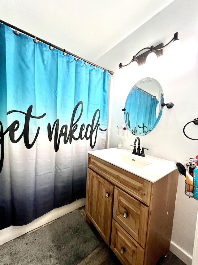 bathroom with curtained shower and vanity