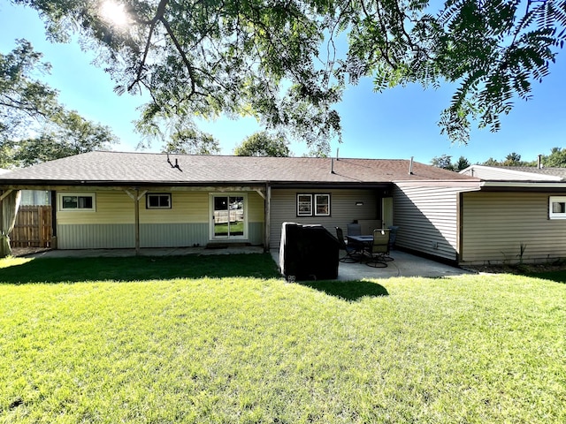 rear view of property with a patio area, a yard, and fence