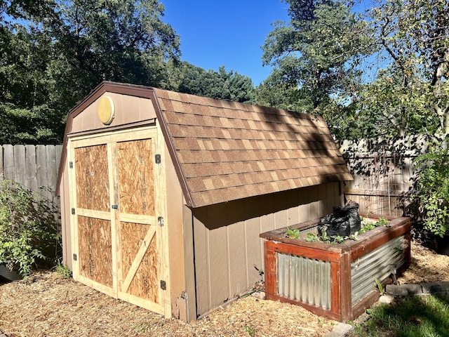 view of shed with fence