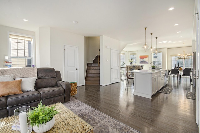 2822 Purley Ave, Ann Arbor, MI 48105 - living room with baseboards, a notable chandelier, dark wood-style floors, stairway, and recessed lighting