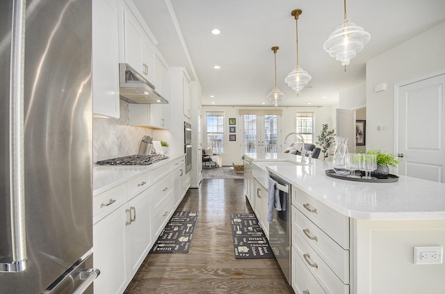 2822 Purley Ave, Ann Arbor, MI 48105 - kitchen with appliances with stainless steel finishes, under cabinet range hood, white cabinetry, recessed lighting, and a center island with sink