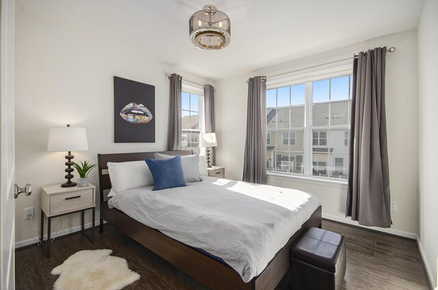 2822 Purley Ave, Ann Arbor, MI 48105 - bedroom with baseboards, dark wood-style flooring, and an inviting chandelier