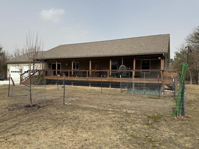 view of front facade featuring an attached garage and a shingled roof