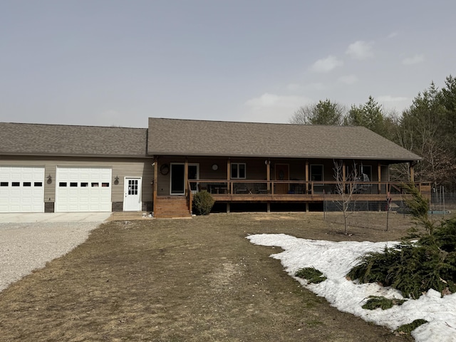 view of front of home with an attached garage, covered porch, and driveway