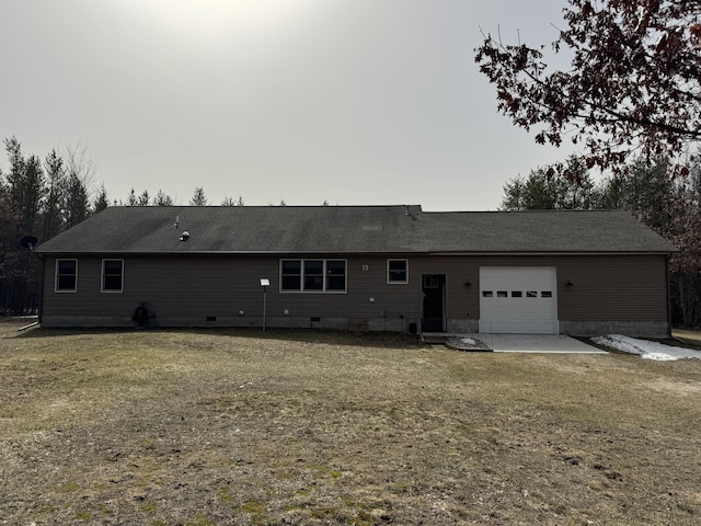 back of property with crawl space, a lawn, a shingled roof, and a garage