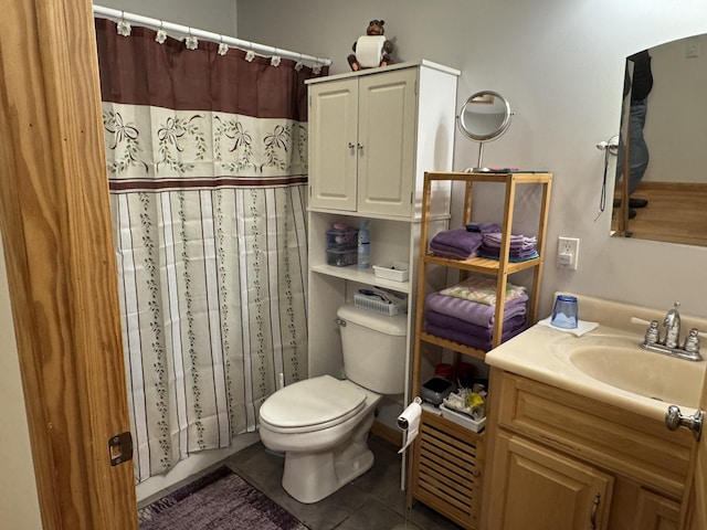 bathroom featuring curtained shower, toilet, vanity, and tile patterned flooring