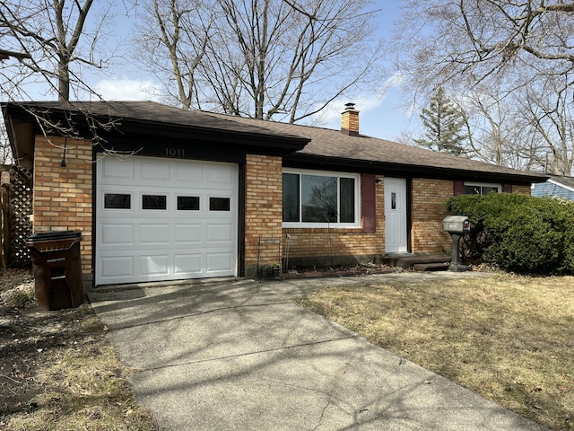 single story home featuring driveway, brick siding, an attached garage, and a chimney