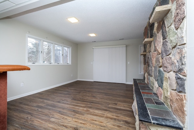 4355 S Lapeer Rd, Metamora, MI 48455 - unfurnished living room featuring a textured ceiling, baseboards, and wood finished floors
