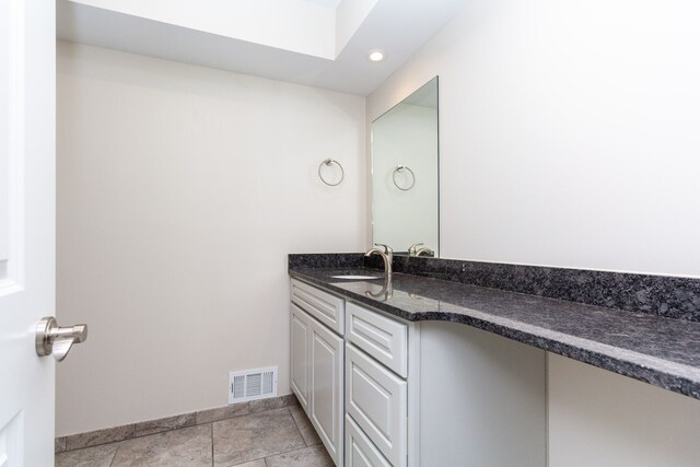 4355 S Lapeer Rd, Metamora, MI 48455 - bathroom featuring vanity, baseboards, visible vents, a skylight, and tile patterned flooring