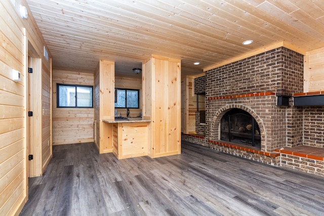 4355 S Lapeer Rd, Metamora, MI 48455 - unfurnished living room with a brick fireplace, wood walls, wooden ceiling, and dark wood-style flooring