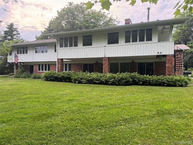 4355 S Lapeer Rd, Metamora, MI 48455 - view of front facade featuring brick siding, a front yard, and a chimney