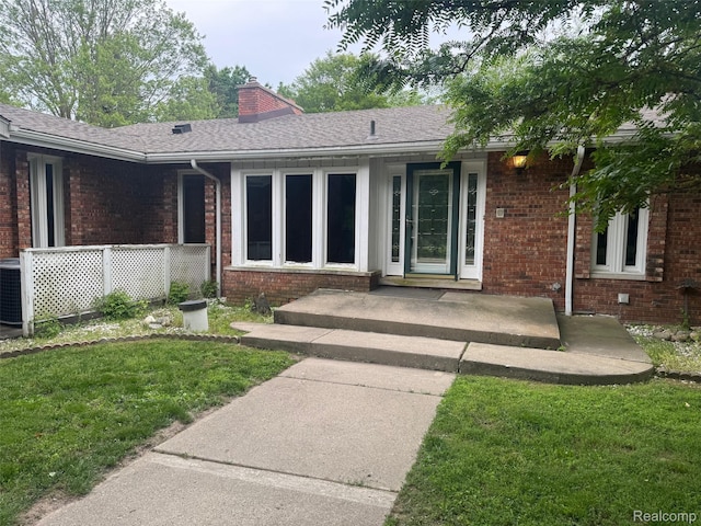 4355 S Lapeer Rd, Metamora, MI 48455 - entrance to property featuring brick siding, a lawn, a chimney, and a shingled roof