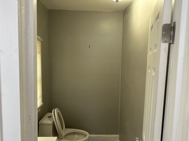 half bathroom featuring toilet