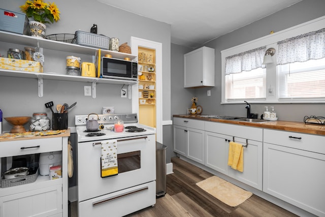 kitchen featuring a sink, dark wood-style floors, wooden counters, and white electric stove