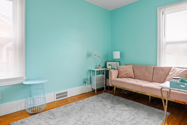 sitting room featuring visible vents, baseboards, and wood finished floors