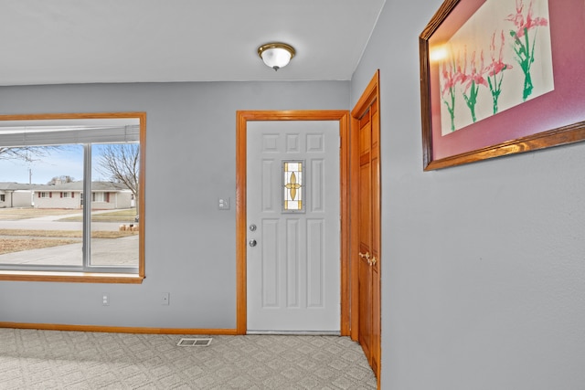 foyer with visible vents and baseboards