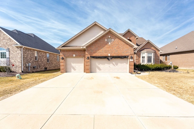 traditional-style house with brick siding, an attached garage, concrete driveway, and a front yard