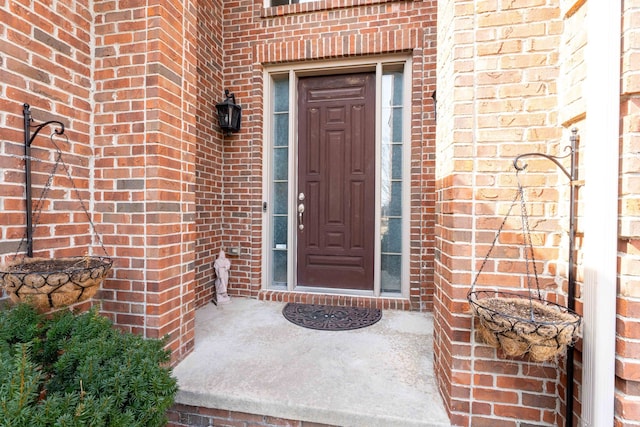 property entrance featuring brick siding