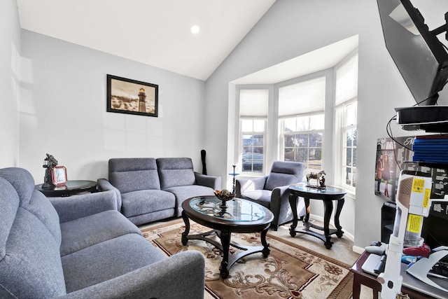 living room with baseboards and high vaulted ceiling