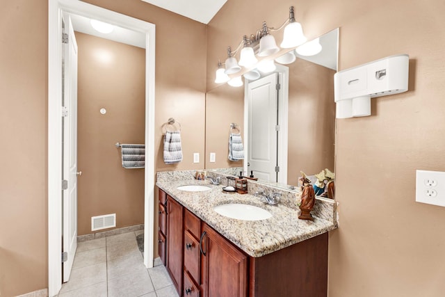 full bathroom featuring tile patterned floors, double vanity, visible vents, and a sink