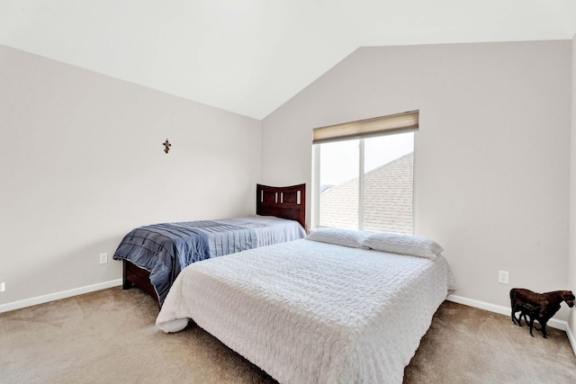 carpeted bedroom with baseboards and vaulted ceiling