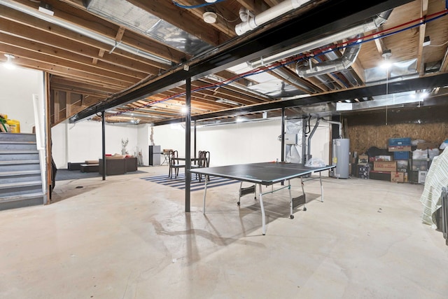 unfinished basement with stairs and water heater