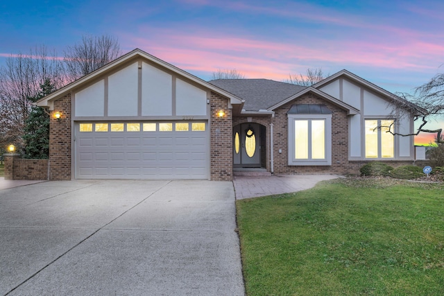 view of front facade with brick siding, an attached garage, a shingled roof, a front lawn, and driveway