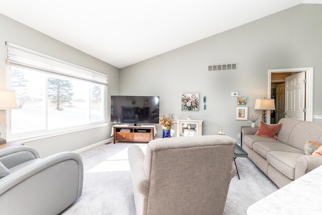 living area featuring light carpet, visible vents, baseboards, and lofted ceiling